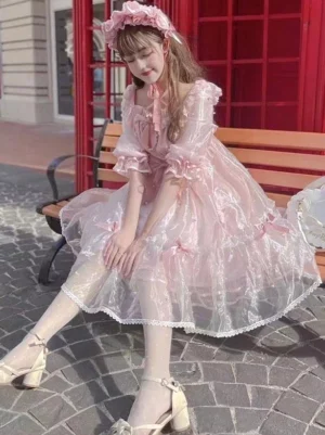 Pink sweet lolita hime dress side view outdoor setting displaying puffy ruffled sleeves and tulle skirt silhouette