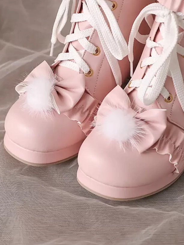 Pink lolita ankle boots close-up flat lay paired boots round toe lace-up bow decoration fluffy pompom trim flat lay showcase