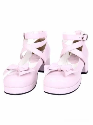 Pair of sweet pink lolita block heel shoes with crisscross ankle straps and front bow buckle ornament studio display