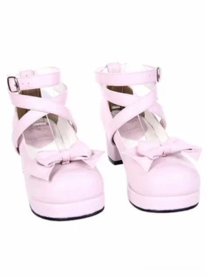 Side front angle of pink lolita block heel shoes showing crisscross ankle straps rounded toe and adorable bow detail