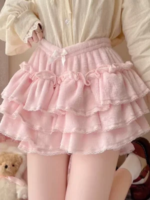 Pink ruffled lolita bloomers side view detail shot with beige blouse and leather loafers, showcasing fluffy velvet material and layered ruffle construction