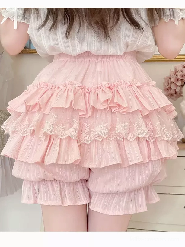 Pink matte lolita bloomers pumpkin pants shape with ruffled tiers and small decorative bows on leg cuffs detail shot