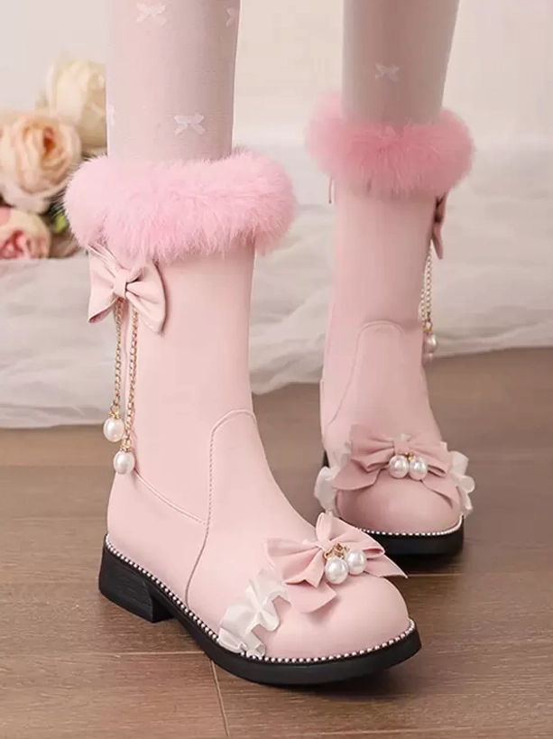 Pink lolita mid-calf boots with pink fuzzy collar and pearl tassel bow accents, worn with bow-patterned tights near floral bouquet, mixed angles