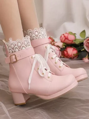 Top-down three-quarter view of pink Lolita boots showing polished PU leather finish, classic lace-up laces, block heel construction, paired with lace-cuff white socks on romantic rose background