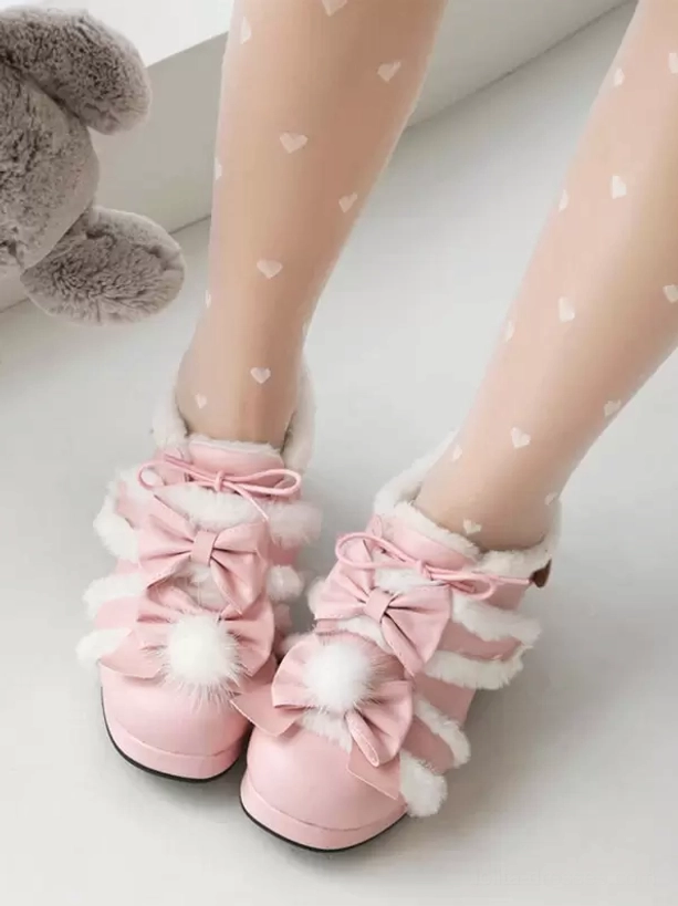Top-down front view of pink lolita bow pumps with white fuzzy trims and round block heel, paired with heart-patterned sheer tights
