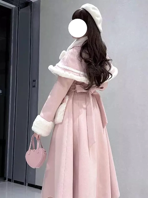Back three-quarter view pink lolita cape coat showing waist sash and layered skirt, model wearing white beret and dark wavy hair