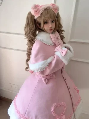 Pink lolita cape coat side back angle view showing A-line silhouette fur-trimmed collar and bow decoration details