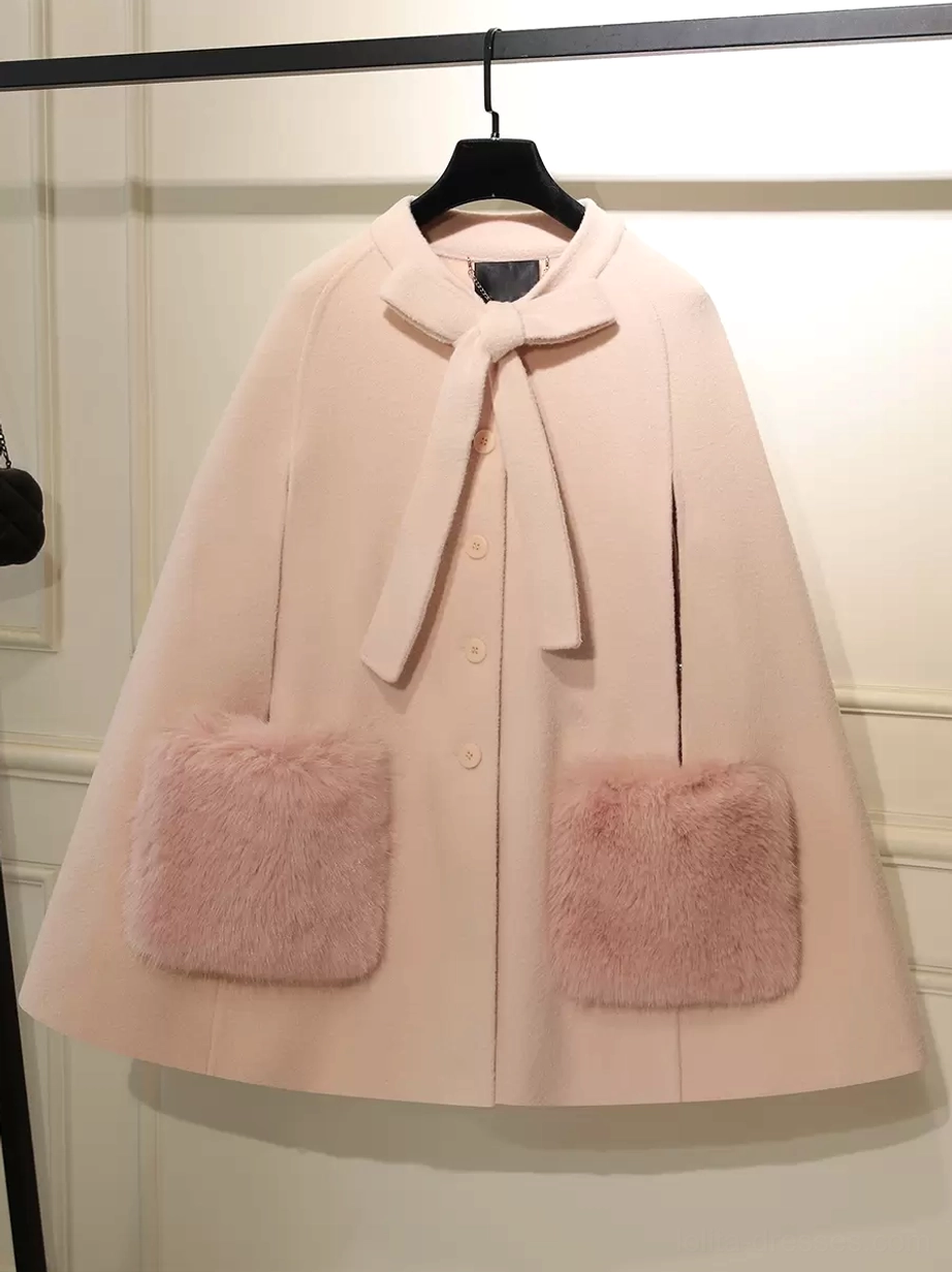 Pink lolita winter cape coat with matching pink fuzzy square pockets and bow collar front hanging view