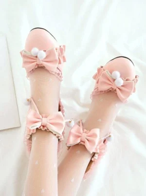 Pink lolita round toe high heel sandals featuring ruffled ankle straps and fluffy pom-pom bow embellishments, direct overhead view of both feet