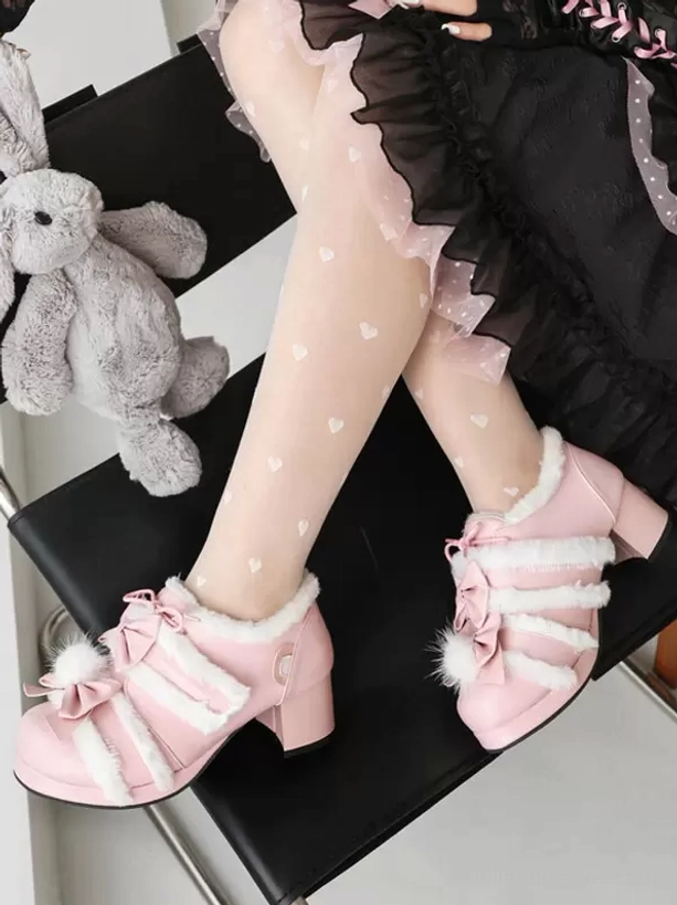 Pink lolita chunky heel shoes with pom-pom bow accent and fuzzy stripes, low angle shot of legs dangling from chair with rabbit plush toy
