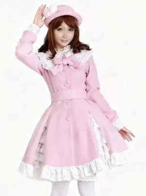 Pink lolita coat dress with lace peter pan collar, front bow, belted waist, and ruffled hem detail - front three-quarter view on model wearing pink bowler hat