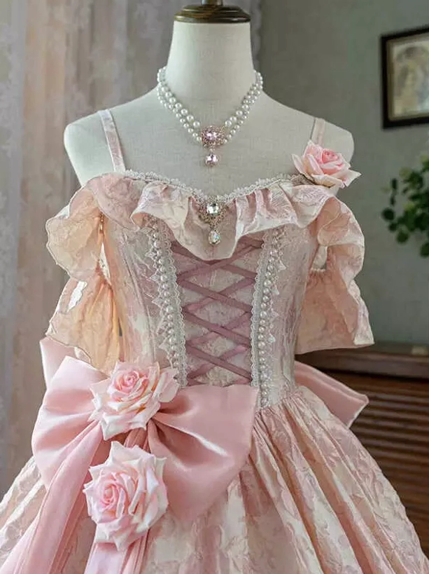 Pink Classic Lolita dress bodice close-up featuring pink jacquard fabric lace-up corset front and large back bow embellished with pink roses