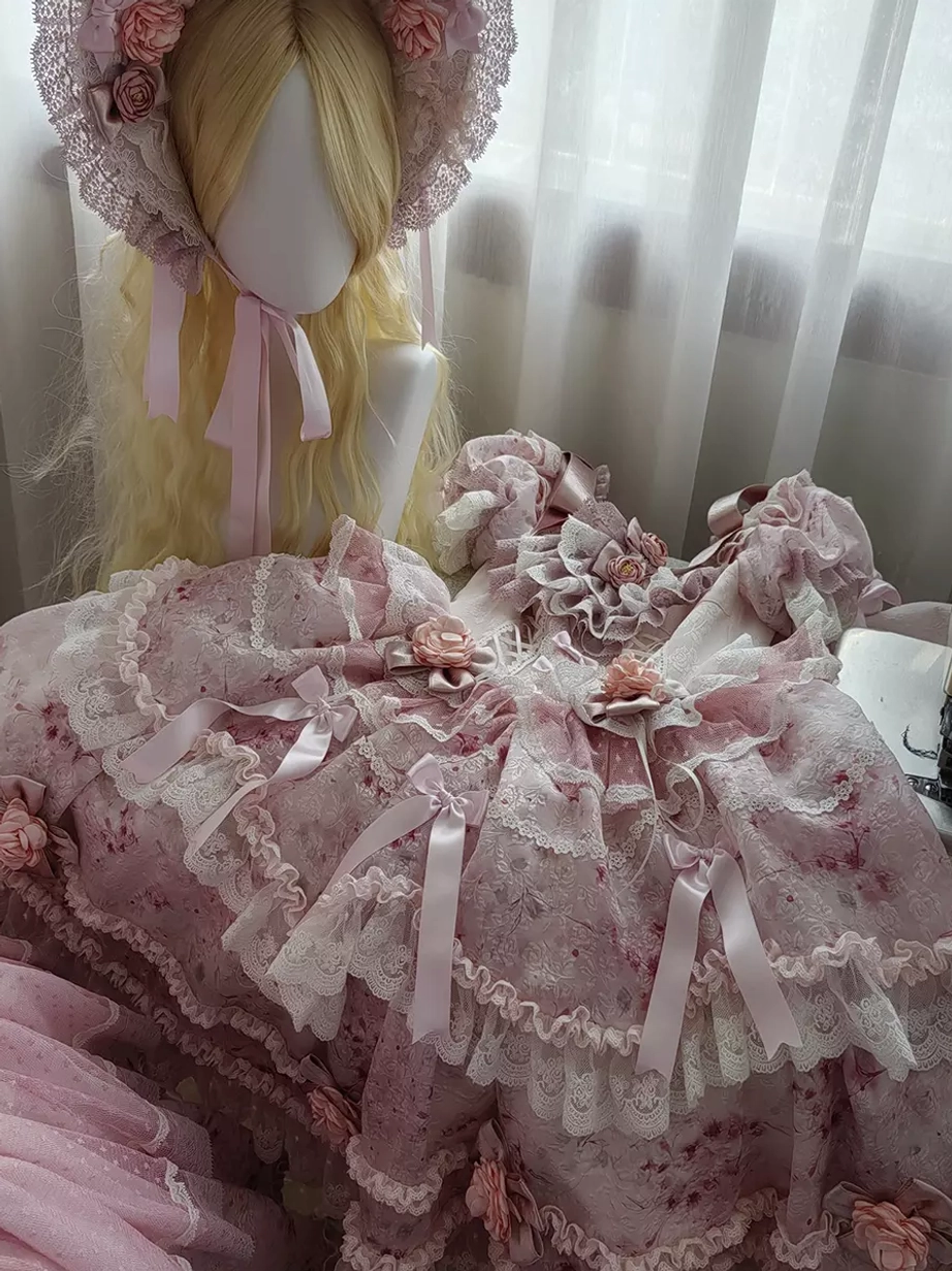 Pink floral lolita dress set top-down close-up shot lace ruffles satin bows 3D flower ornaments matching flower bonnet styling