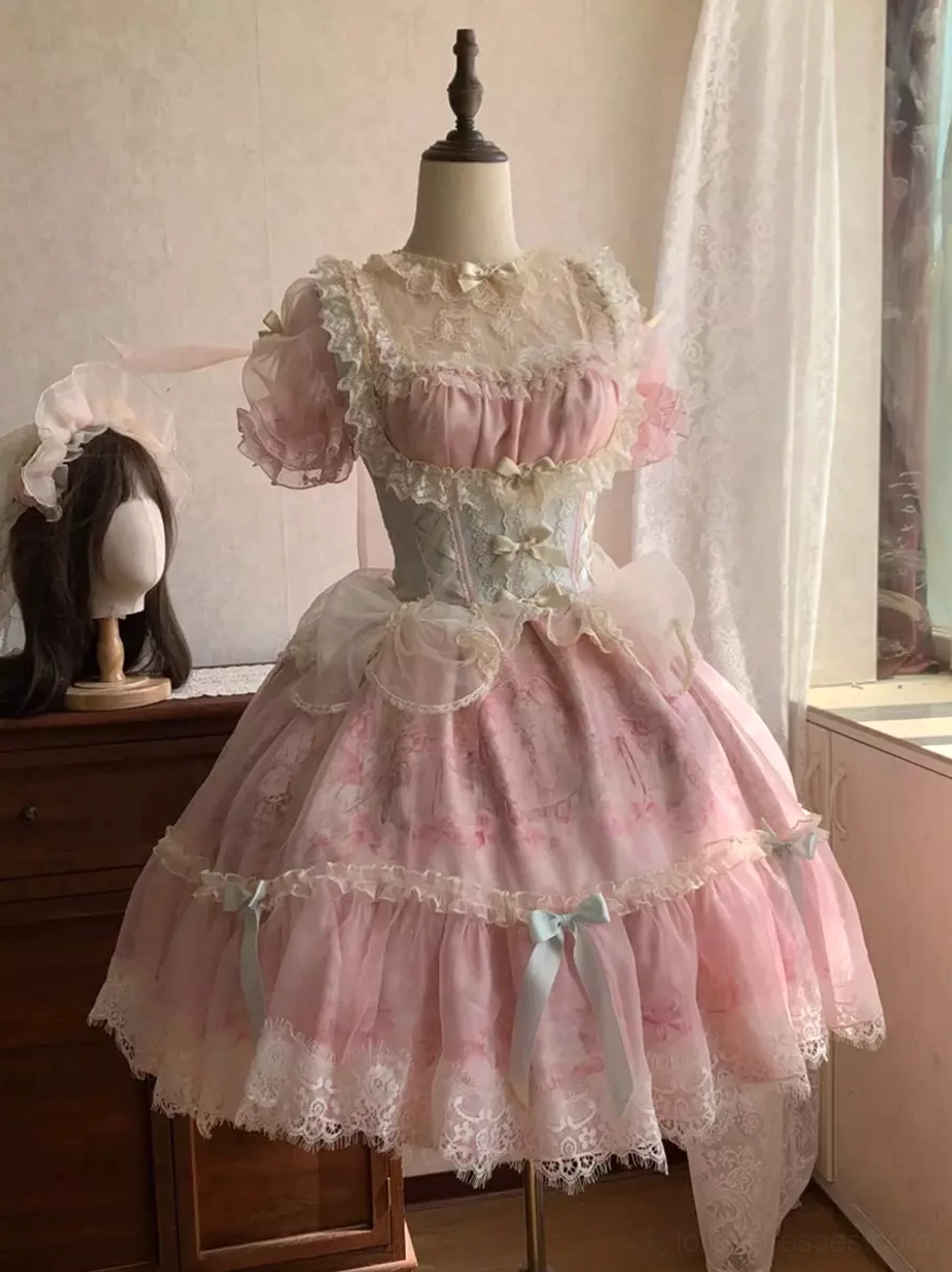 Sweet pink lolita dress on mannequin showing sheer lace collar layered tulle skirt mint green bows full display view
