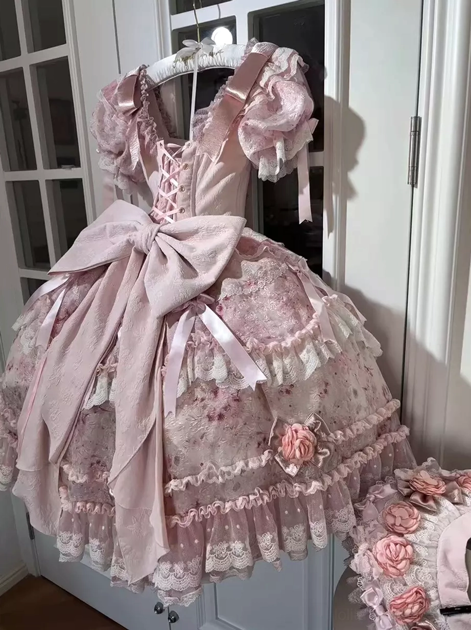 Light pink lolita dress back three-quarter view on hanger lace-up corset back design oversized satin bow ruffled short sleeves