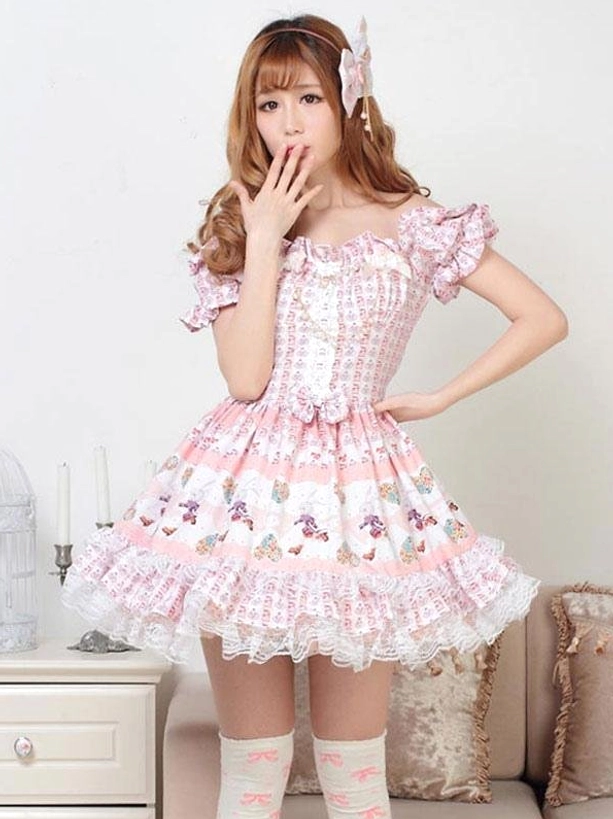 Pink off-shoulder lolita one-piece dress with shirred bust waist bow detail and lace trim on model with pink hair bow