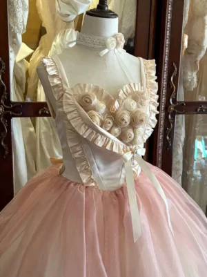 Pink lolita dress upper bodice detail, side-front close-up showing ruffled shoulder straps, satin rose embellishments, decorative waist bow, vintage background