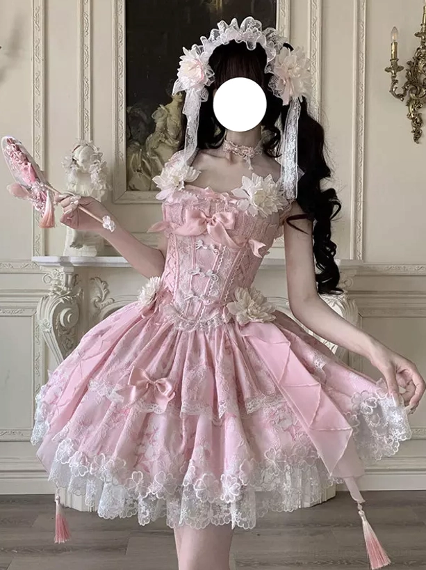 Pink lolita dress front view displaying floral appliques ruffled layered skirt and sweet romantic aesthetic design