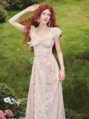 Side front view of pink lolita fairy dress with drawstring waist and puff cap sleeves on model in grass garden backdrop