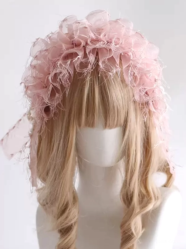 Front view of light pink sweet lolita headdress featuring full ruffled organza design with frayed edges and sheer side scarves on blonde curly wig mannequin