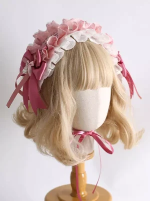 Pink sweet lolita headband three-quarter left angle showcasing gradient pink ruffles, white eyelet lace details, dual side bows, intricate layered construction - lolita fashion accessory
