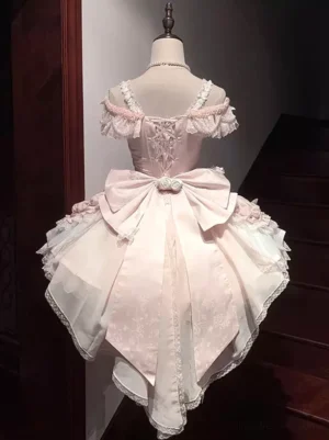 Back view of pink lolita corset dress showcasing lace-up back closure design, large satin bow, and gradient tulle hem with delicate lace trim detailing