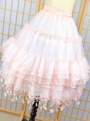 Rear three-quarter view of pink Lolita petticoat showing layered ruffles, sparkly sheer tulle construction, and star fringe trim detail