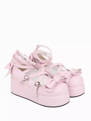 Pink Lolita platform pumps side three-quarter view highlighting thick wedge platform sole, bow accents on toe and heel, and chunky heel profile