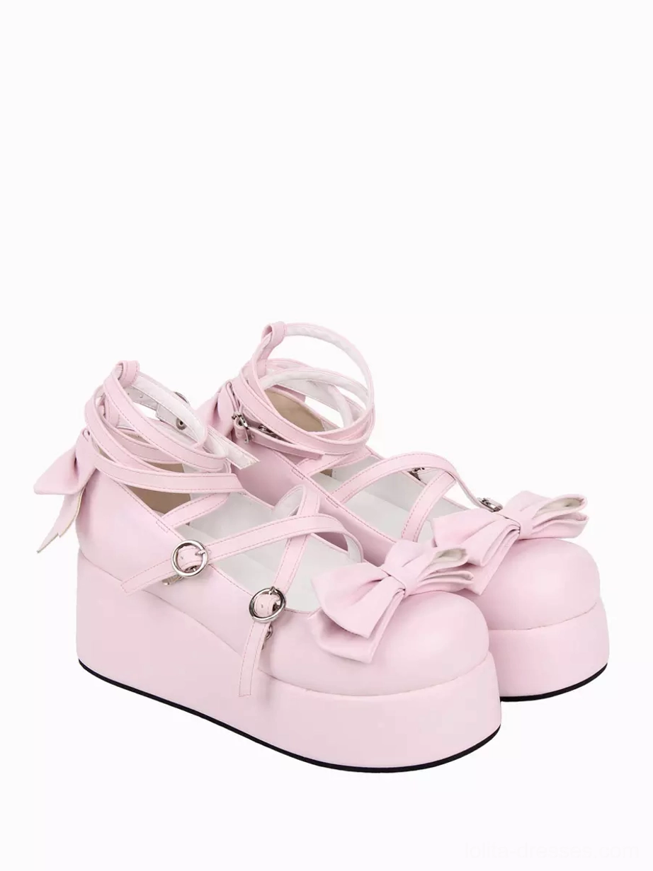 Pink Lolita platform pumps side three-quarter view highlighting thick wedge platform sole, bow accents on toe and heel, and chunky heel profile