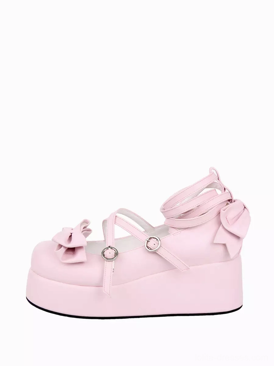 Single pink Lolita platform pump side view displaying ankle wrap straps, front and heel bows, matte polyurethane finish, and rounded toe on white background