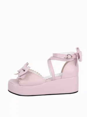 Pink lolita peep-toe platform sandals left side front view displaying front bow with lace detailing and ankle buckle with back bow embellishment