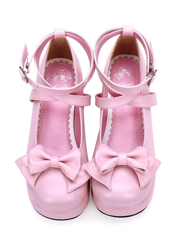 Pink Lolita platform shoes with matte pink finish, prominent front bow, and dual ankle straps with functional buckles direct front view on plain white background