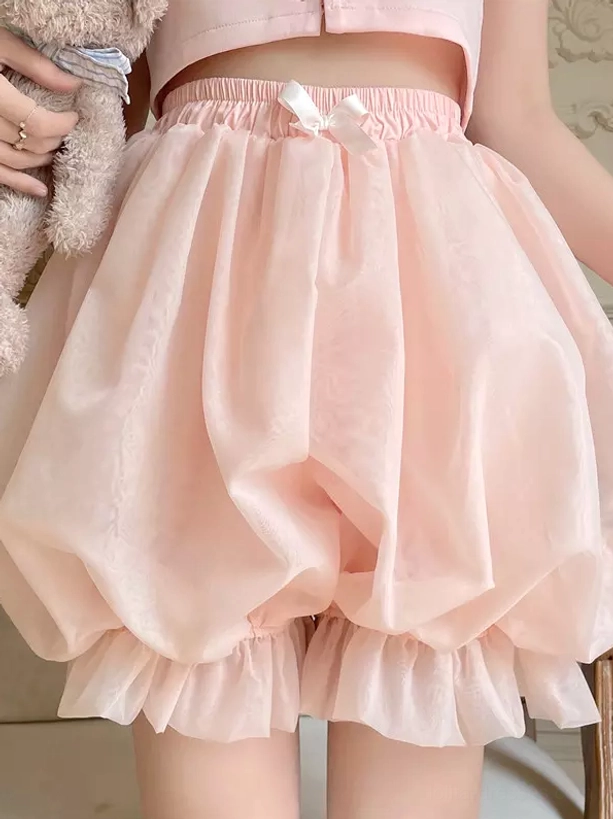 Pink lolita pumpkin safety shorts front view with ruffled hem small waist bow soft puffy design worn on model holding teddy bear