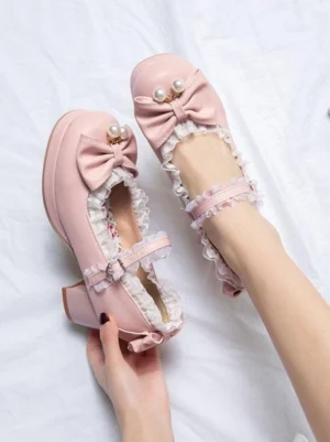 Pink lolita pumps on model foot pearl bow lace ankle strap block heel side profile demonstration