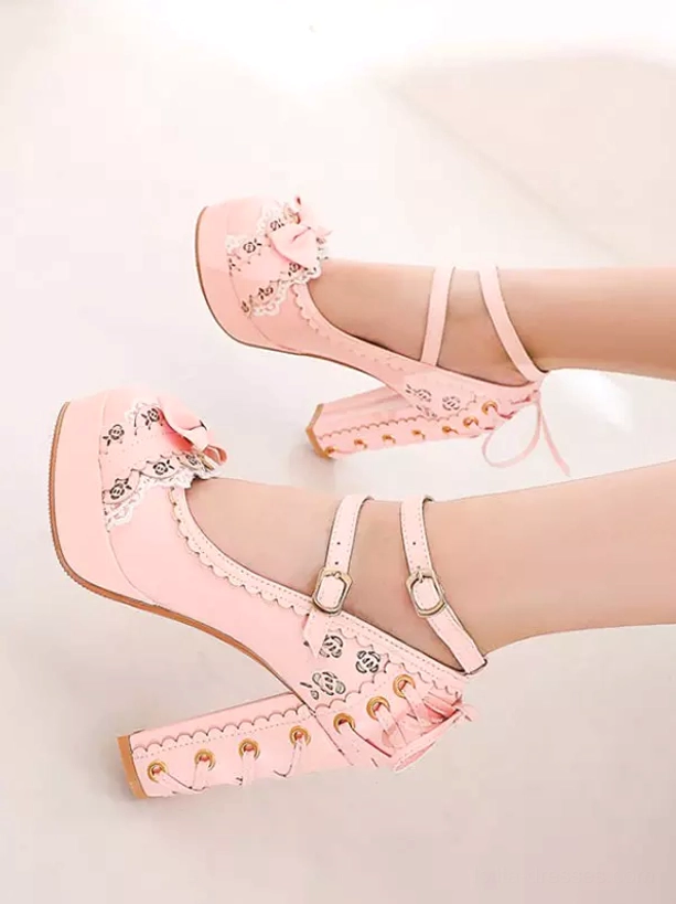 Pink lolita pumps single foot side view showing lace-up block heel, ankle strap and bow on toe cap detail