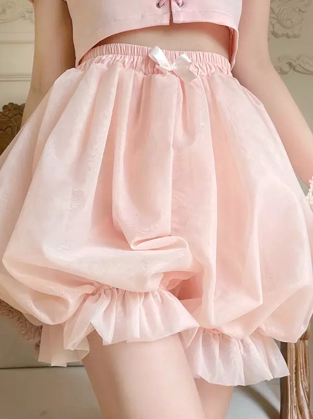 Side view pink lolita safety shorts displaying ruffled leg edge elastic waist bow light pink color voluminous puffy silhouette