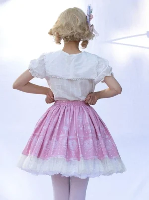 Pink lolita skirt back view showing elastic waistband and white lace trim details on blonde model