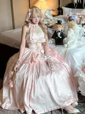 Pink lolita wedding princess gown sitting three quarter view with lace gloves and pink purse halter bow collar