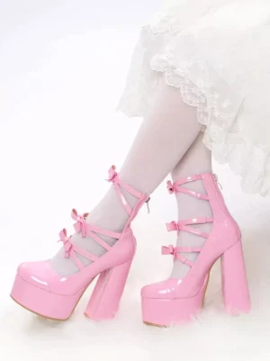 Pink patent leather platform Lolita boots front three-quarter view with white lace dress and white stockings showcasing shiny glossy finish and decorative crisscross ankle straps with delicate pink bows
