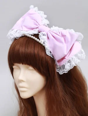 Pink lolita headdress with pearl headband and decorative bow, front full face view on mannequin, displaying complete lace trim detailing and pearl chain arrangement for lolita fashion coordination