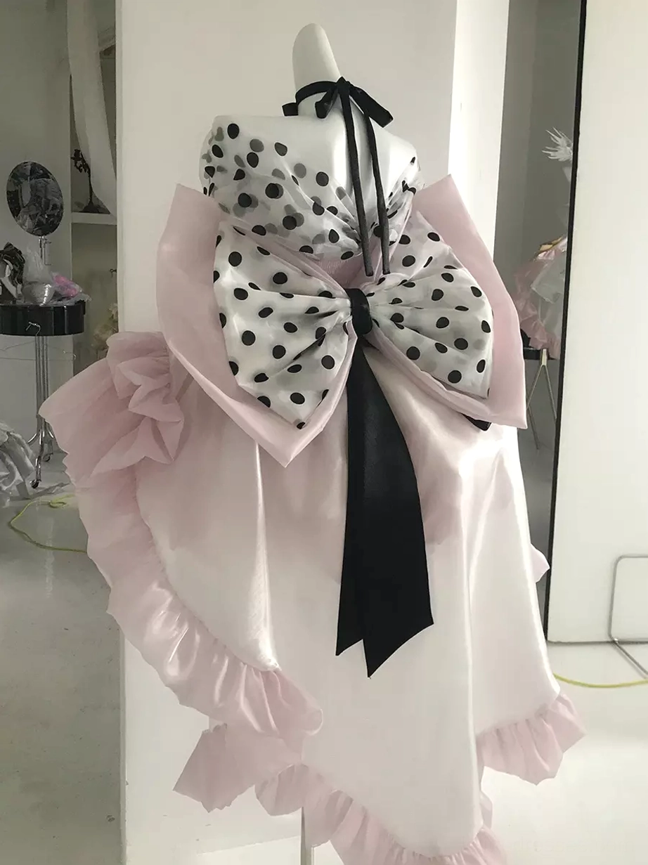 Pink polka dot ballet lolita dress back three-quarter view large back polka dot bow long black sash ruffled trim