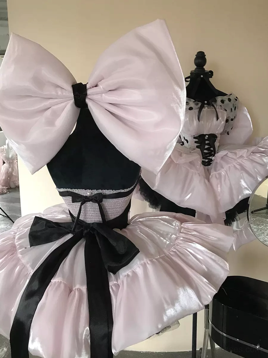 Pink polka dot lolita dress with theatrical elements oversized bow ruffled skirt perfect for fashion photography and editorial shoots