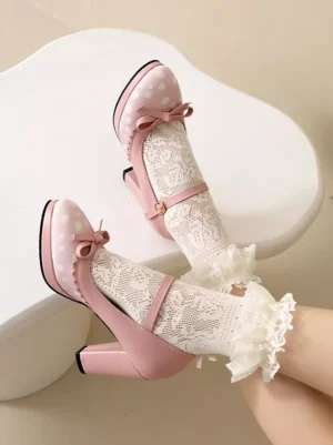 Pink Mary Jane style Lolita chunky heel pumps with polka dot pattern and tiny bow decor, displayed in top-down close-up on white table, paired with delicate frill lace socks, showcasing ankle strap buckle detail