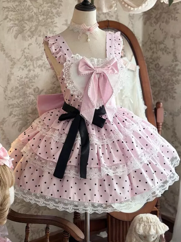 Pink polka dot sweet lolita JSK dress front view with pink chest bow black waist bow and ruffle lace trim details