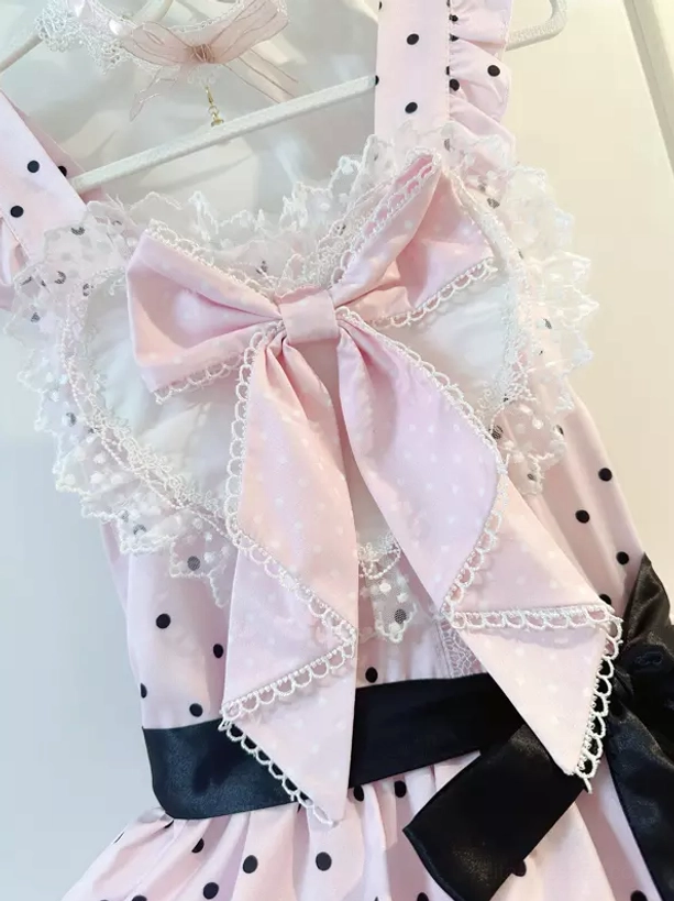 Pink polka dot sweet lolita JSK dress close-up top detail showing pink lace trim big pink chest bow and black polka dots