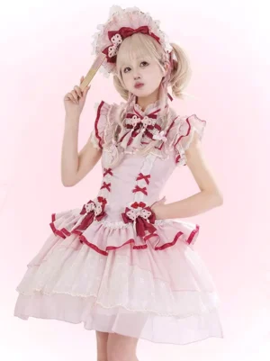 Pink Qi Lolita jumper dress front three-quarter view with tiered tulle skirt ruffled neckline and lace trims worn with matching headdress
