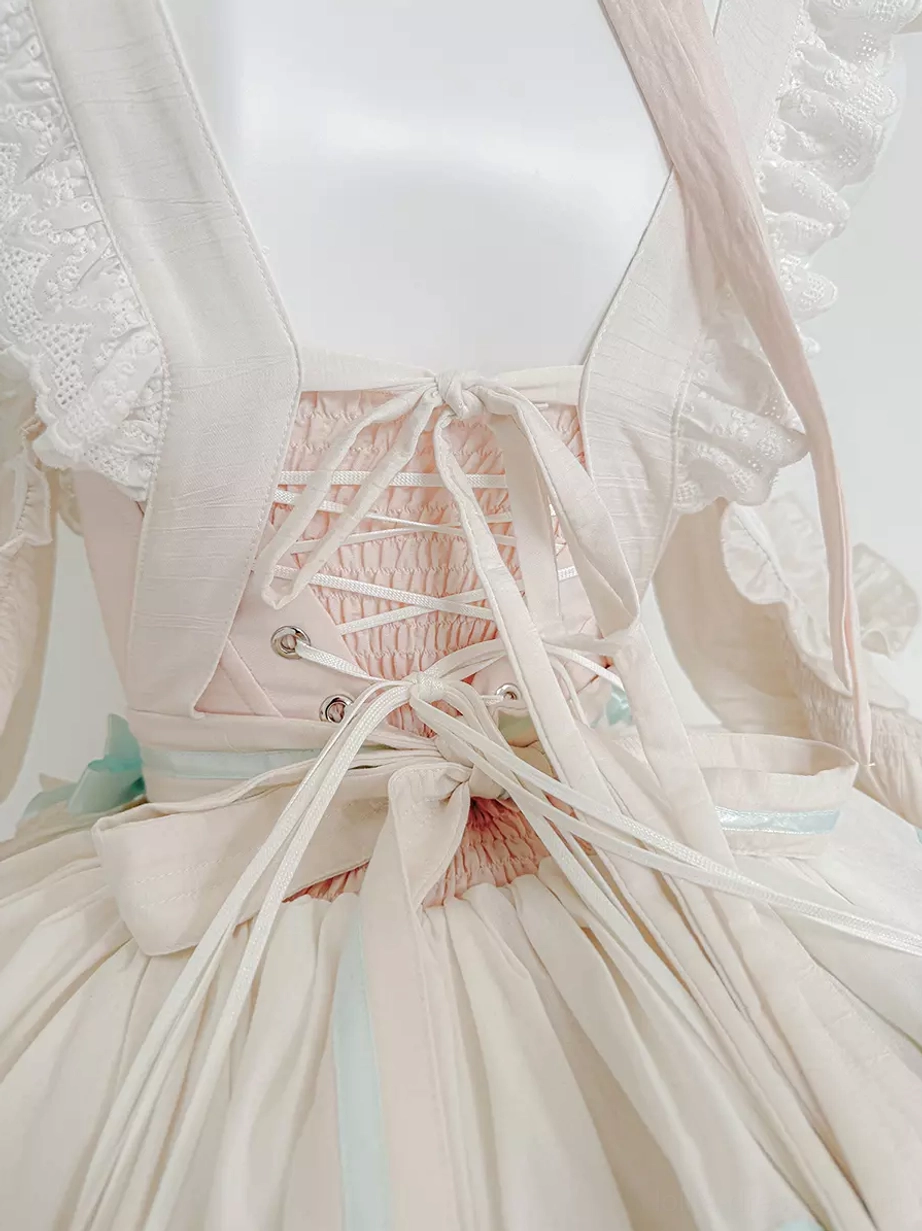 Pink rabbit maid lolita dress close-up detail of bodice showing bow centerpiece, ruffled construction, and meticulous craftsmanship in sweet lolita design