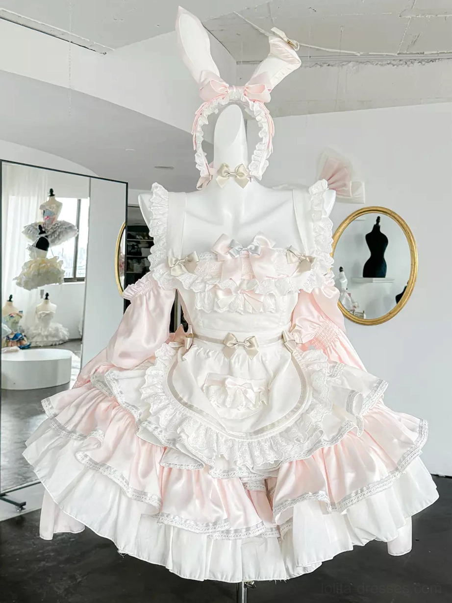 Pink rabbit maid lolita dress full-length front view on dress form showing tiered ruffled skirt, detachable sleeves, bunny ear bow, and sweet aesthetic appeal