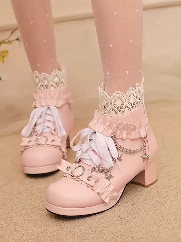 Pink Rococo Lolita ankle boots front close-up on model wearing heart-print sheer socks, ruffle lace detailing, star chain, block heel styling