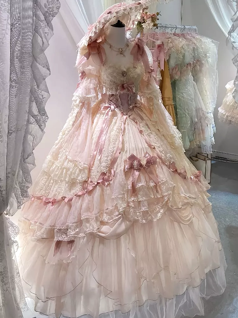 Pink ruffled lolita ball gown with corset style bodice matching hooded headwear tiered ruffle layers full front view
